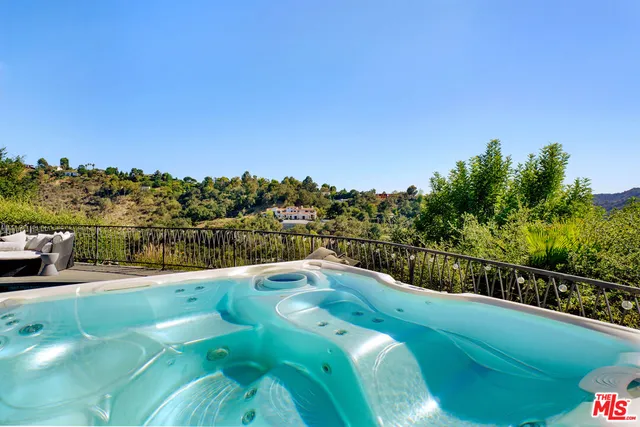 a view of a swimming pool with a yard and mountain view