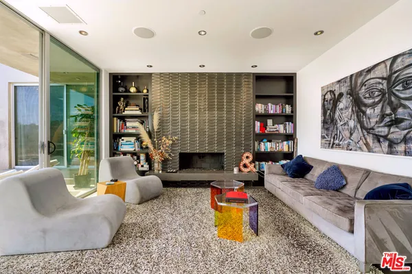 a living room with fireplace furniture and a book shelf