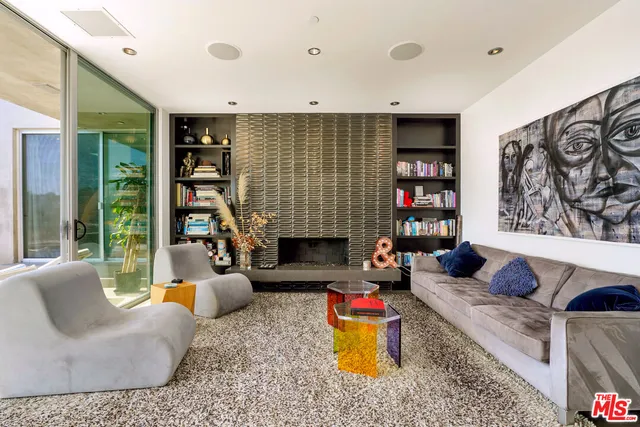 a living room with fireplace furniture and a book shelf