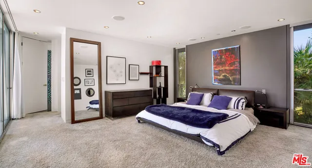 a spacious bedroom with a bed and a walk in closet