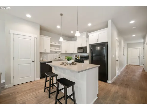 a kitchen with a refrigerator stove and microwave