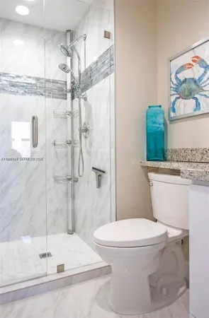 a white toilet sitting next to a bath tub shower