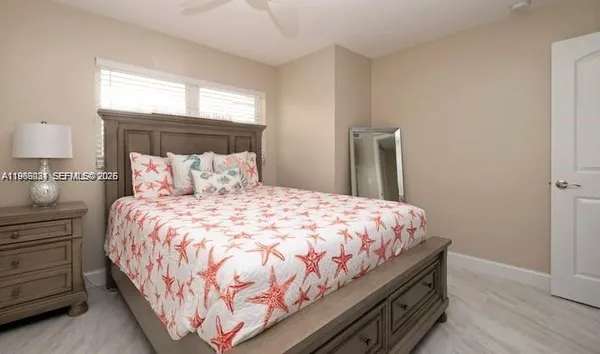a large bed sitting in a bedroom next to a window