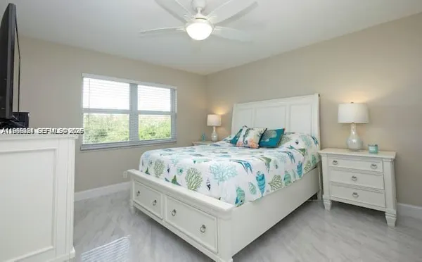 a spacious bedroom with a bed and a window