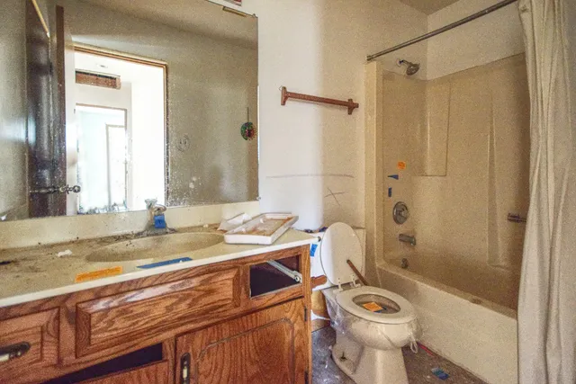 a bathroom with a sink toilet and shower