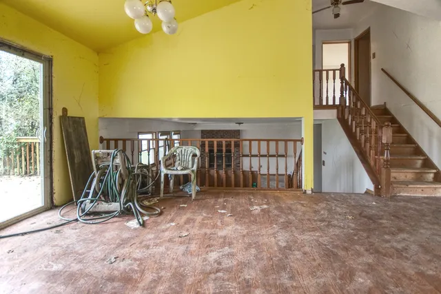 a view of a livingroom with furniture and a window