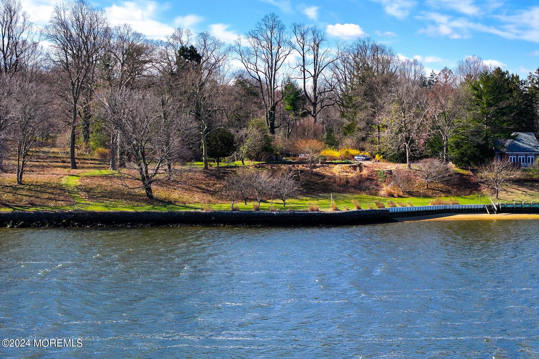 70 River Road Rumson, NJ 07760 - Photo 13 of 30 a view of a swimming pool with an outdoor space and seating area