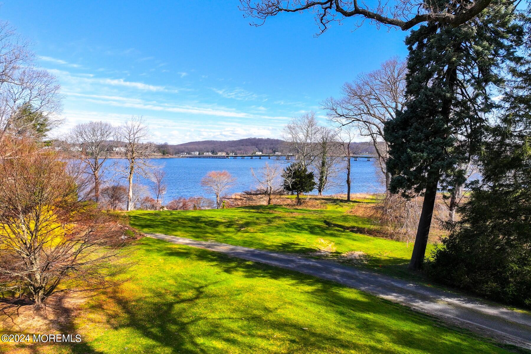 70 River Road Rumson, NJ 07760 - Photo 25 of 30 a view of a lake with a building in the background