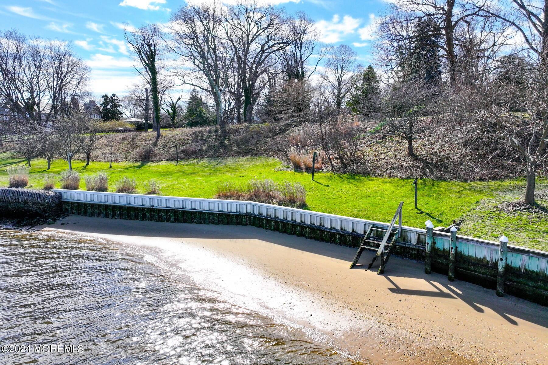 70 River Road Rumson, NJ 07760 - Photo 27 of 30 a view of swimming pool with a patio and yard