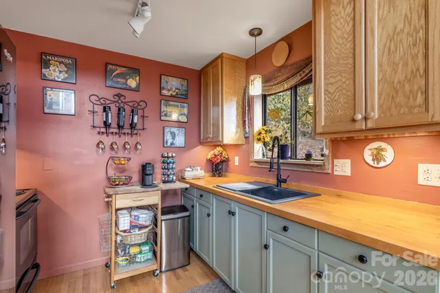 a kitchen with stainless steel appliances a sink and cabinets