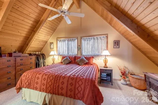 a bed sitting in a bedroom next to a window