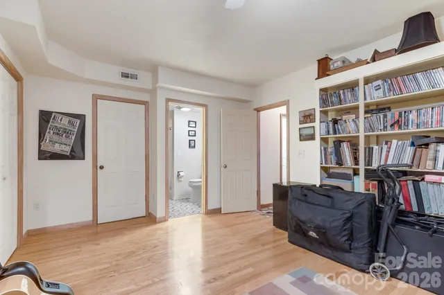a living room with couch and a book shelf