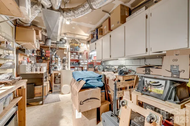 a view of a kitchen with stainless steel appliances granite countertop lots of clutter