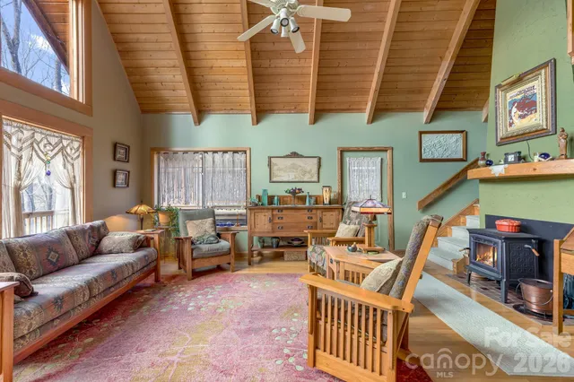 a living room with furniture a fireplace and a large window