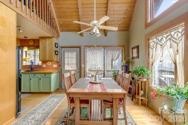 a dining room with furniture potted plants and wooden floor