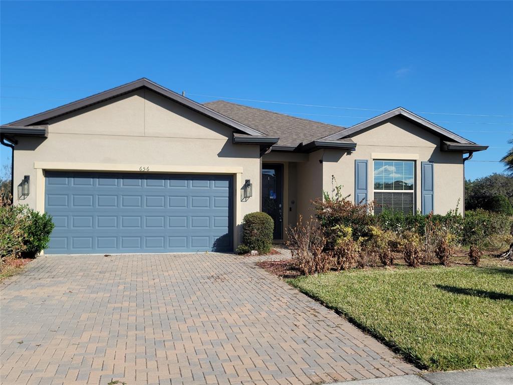 a view of a house with a yard and plants