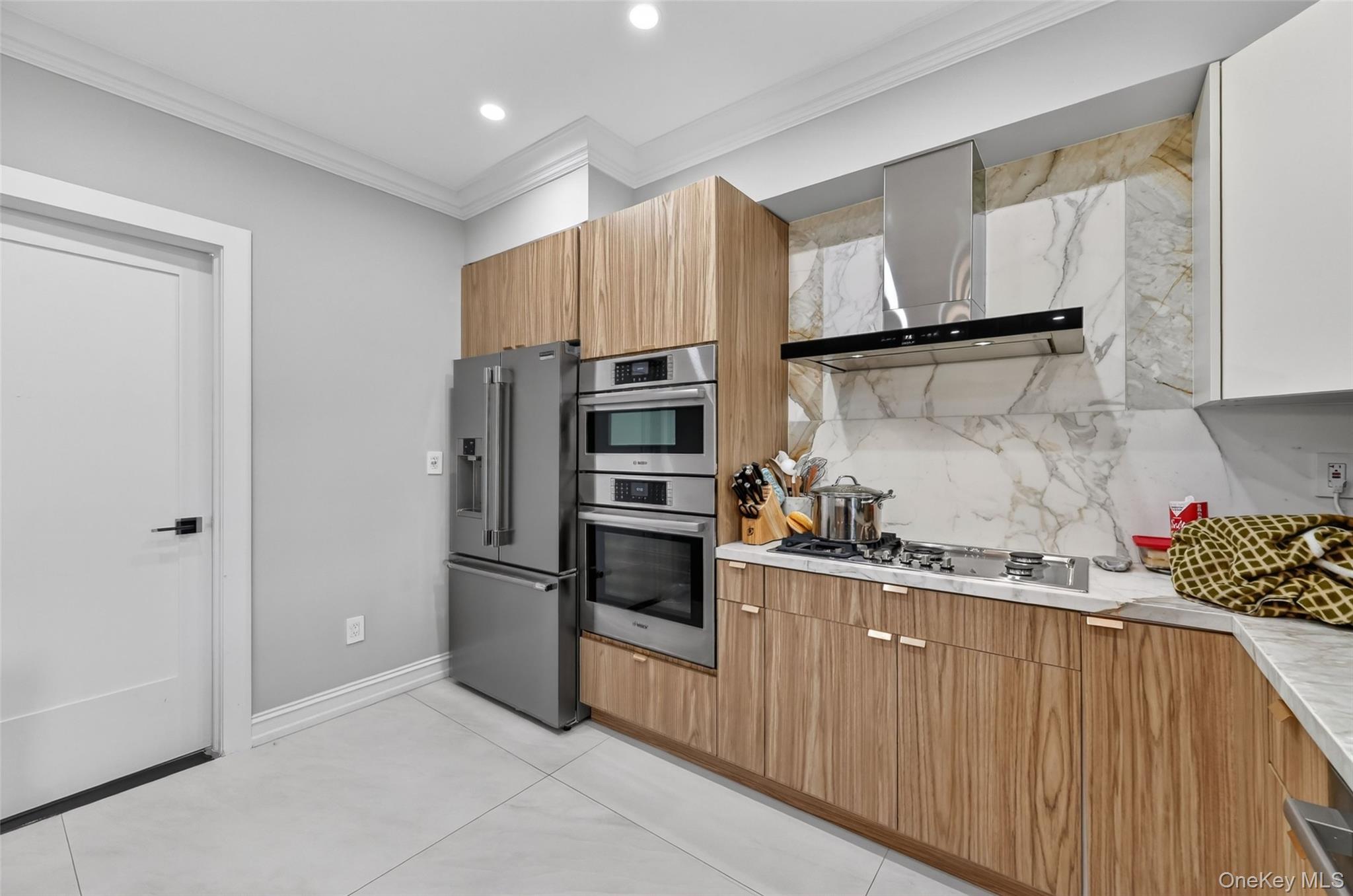 65 Wildway Bronxville, NY 10708 - Photo 37 of 42 Modern kitchen featuring a stainless steel refrigerator, double wall ovens, and a gas cooktop