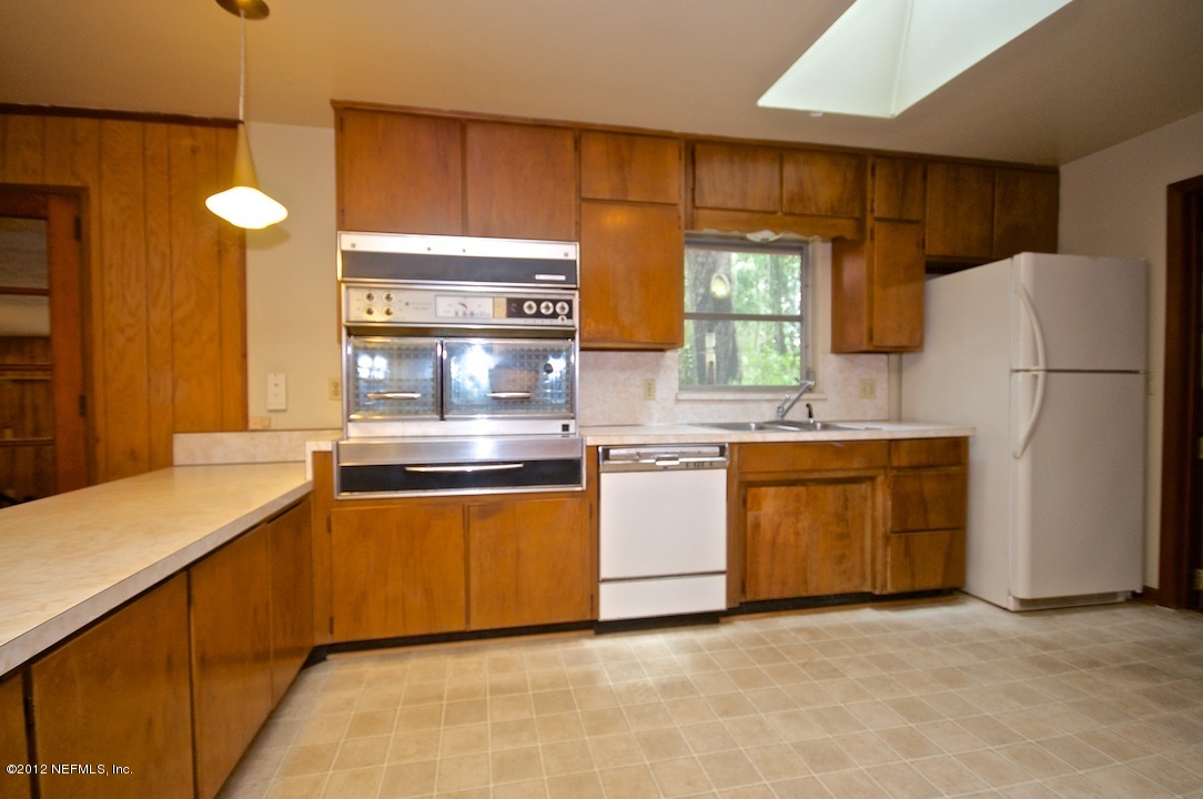 4149 Rogero Road Jacksonville, FL 32277 - Photo 12 of 27 a kitchen with stainless steel appliances granite countertop a stove a sink and a refrigerator