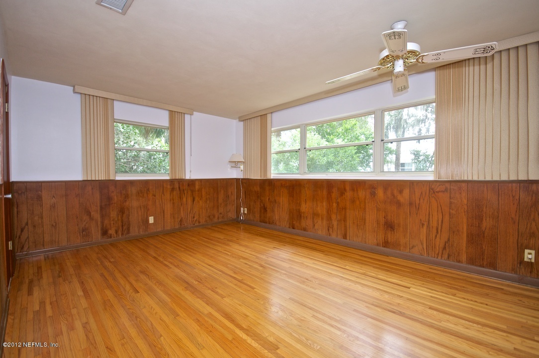4149 Rogero Road Jacksonville, FL 32277 - Photo 15 of 27 wooden floor in an empty room with a window