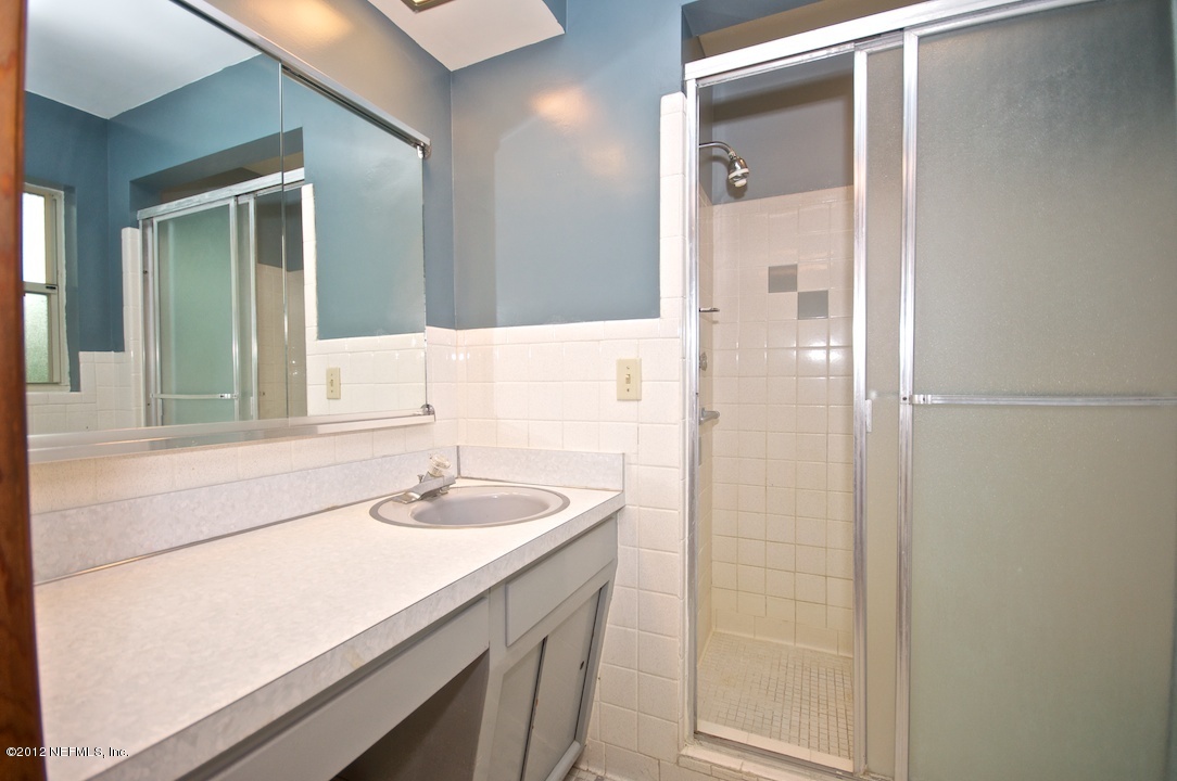 4149 Rogero Road Jacksonville, FL 32277 - Photo 16 of 27 a bathroom with a sink and a mirror