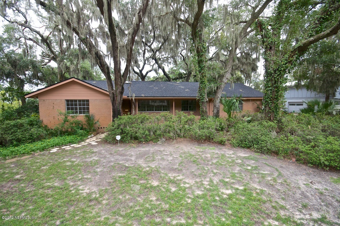 4149 Rogero Road Jacksonville, FL 32277 - Photo 2 of 27 a front view of a house with a garden