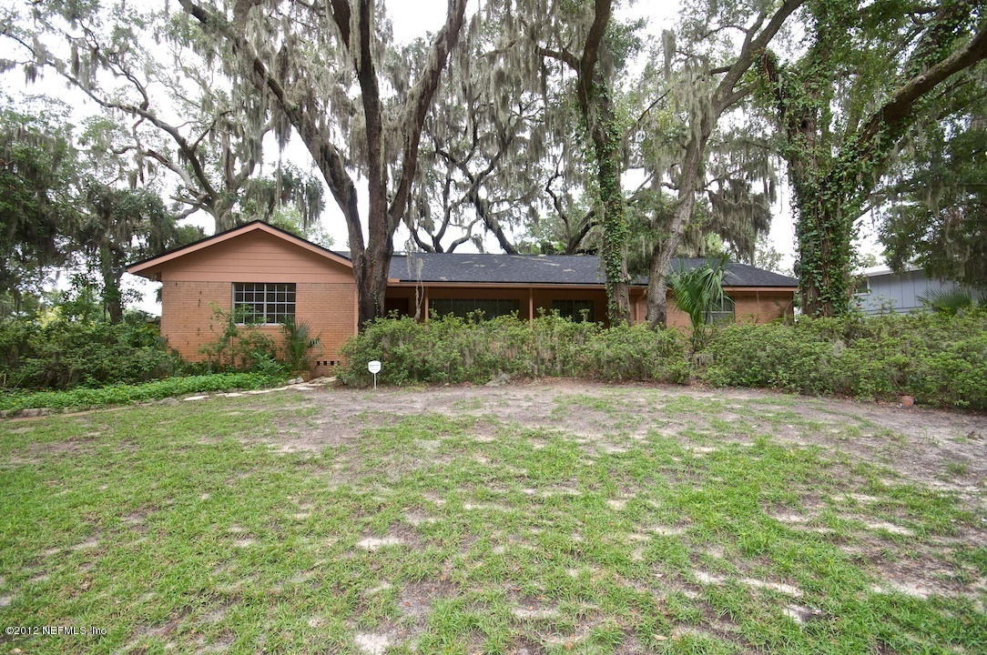 4149 Rogero Road Jacksonville, FL 32277 - Photo 3 of 27 a front view of a house with garden