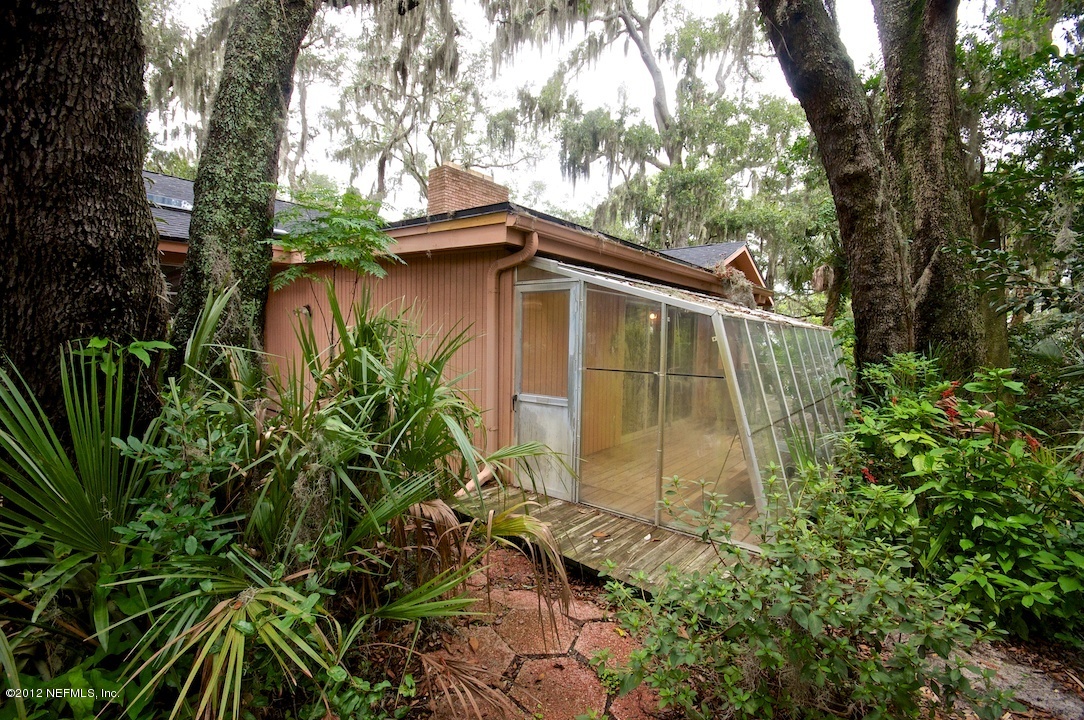 4149 Rogero Road Jacksonville, FL 32277 - Photo 5 of 27 a backyard of a house with lots of green space