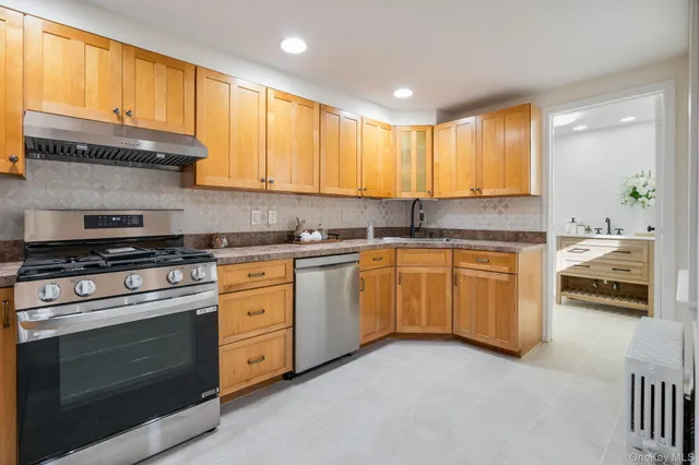 a kitchen with granite countertop a stove sink and cabinets
