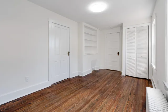 a view of hallway with wooden floor