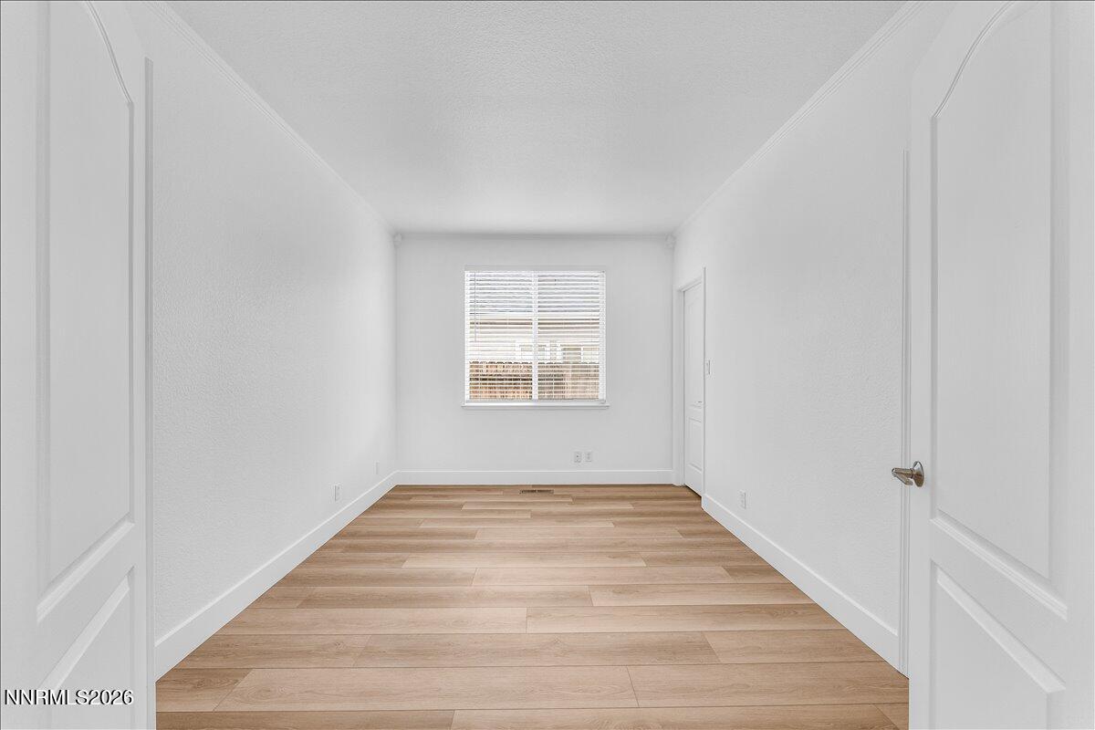 2329 Red Maple Court Reno, NV 89523 - Photo 18 of 39 a view of an empty room with wooden floor and a window