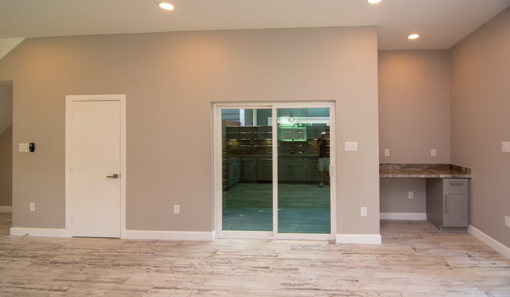 317 West 35th Street Houston, TX 77018 - Photo 11 of 22 an empty room with floor to ceiling window and kitchen
