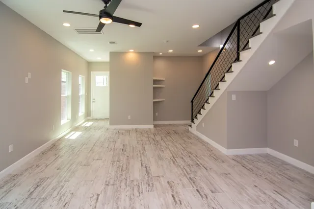 a view of empty room with wooden floor