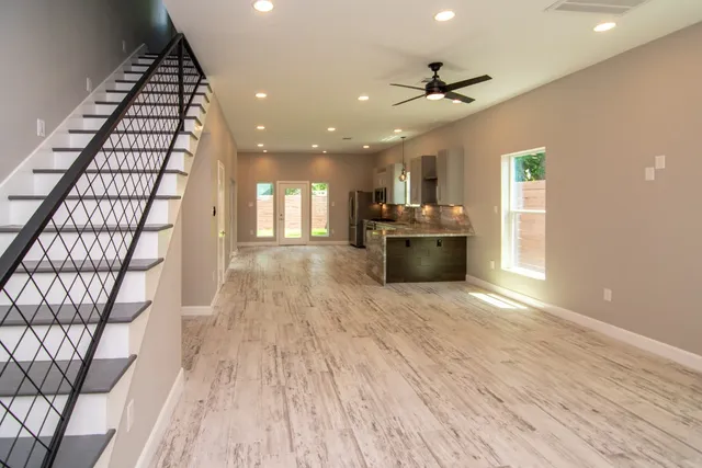 a view of a living room with a sink and wooden floor