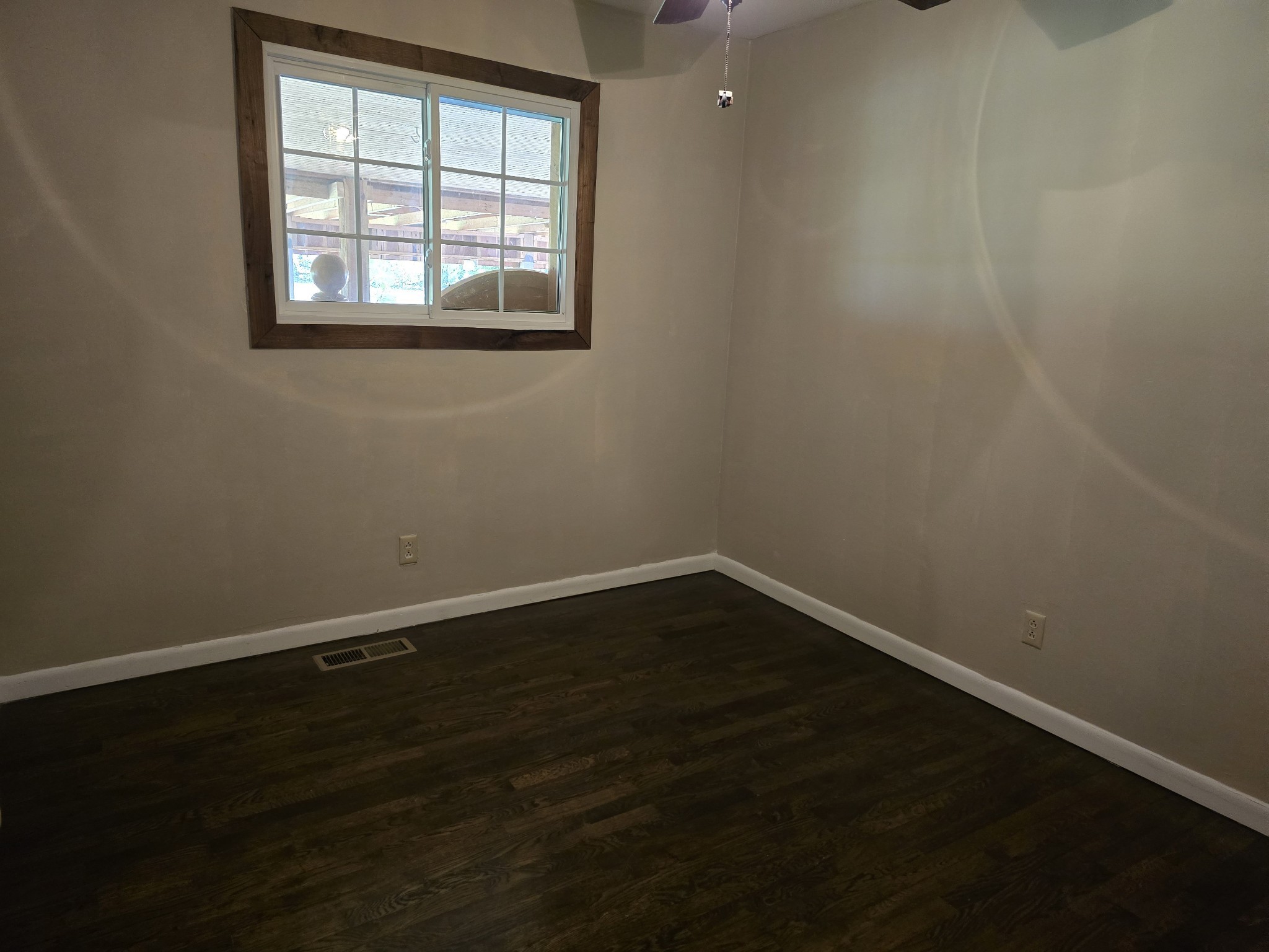 158 Swan Mill Road McMinnville, TN 37110 - Photo 6 of 10 an empty room with wooden floor and windows