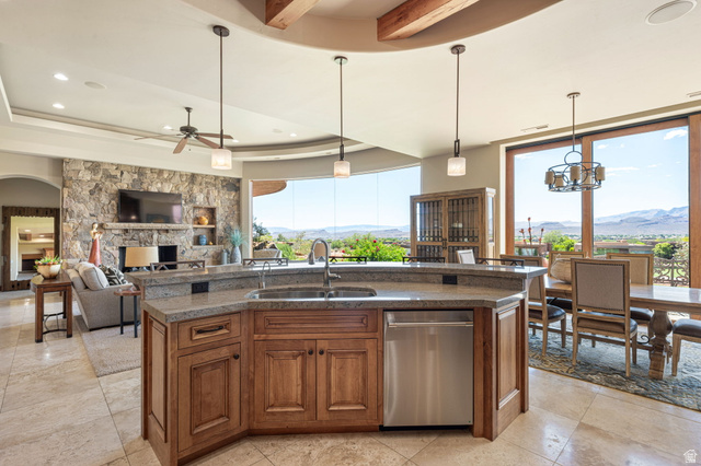 2331 West Entrada Trail, Unit 61 St. George, UT 84770 - Photo 17 of 69 Open-concept kitchen featuring an expansive island with a stainless steel dishwasher, a stone countertop, and pendant lighting