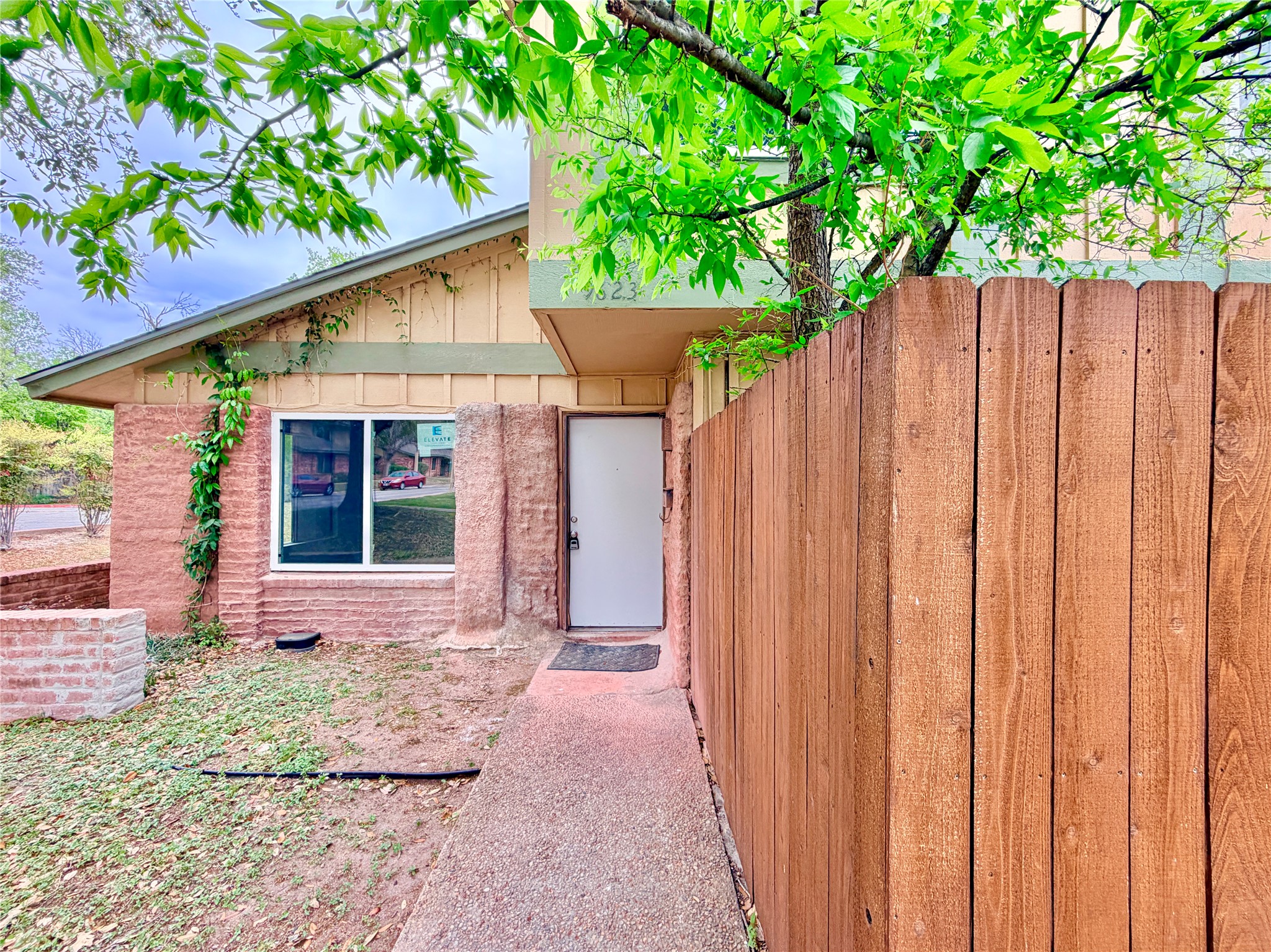 9623 Covey Ridge Lane Austin, TX 78758 - Photo 3 of 40 a front view of a house with a yard and potted plants