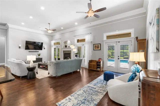a living room with furniture a flat screen tv and a fireplace