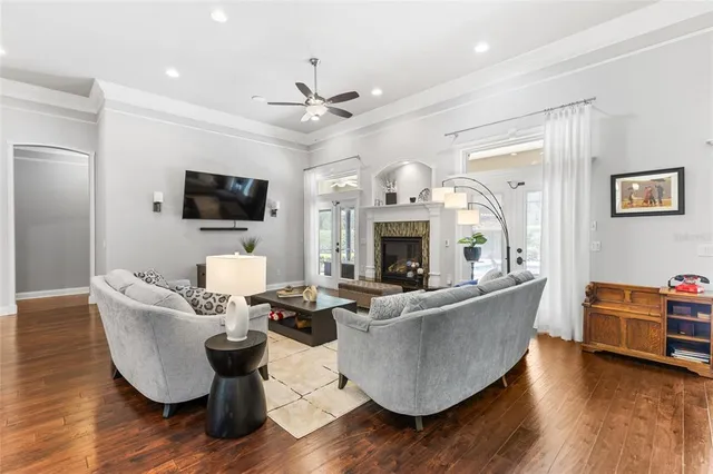 a kitchen with stainless steel appliances kitchen island granite countertop wooden floor and dining table