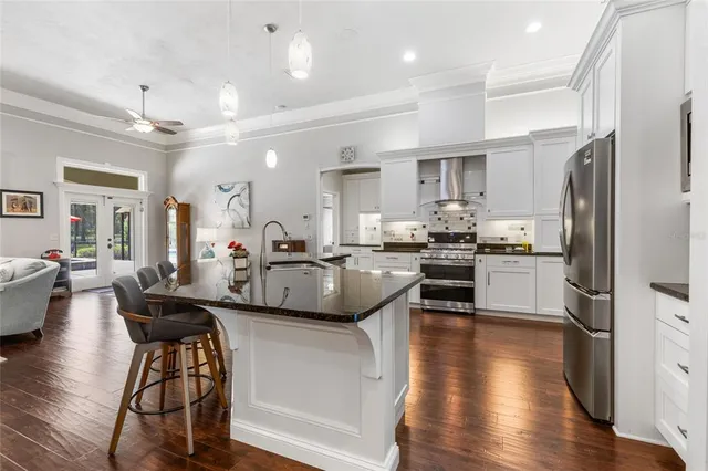 a kitchen with lots of counter top space and stainless steel appliances