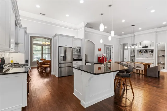 a kitchen with stainless steel appliances a refrigerator stove and microwave