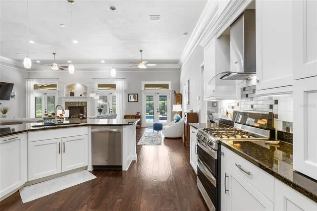 a view of a dining room with furniture wooden floor and chandelier