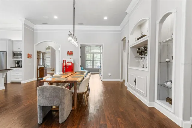 a bedroom with a bed couch and a large window