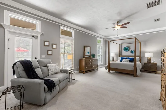 a bedroom with a bed and a chandelier