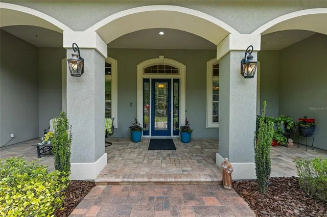 a view of a porch with furniture and garden