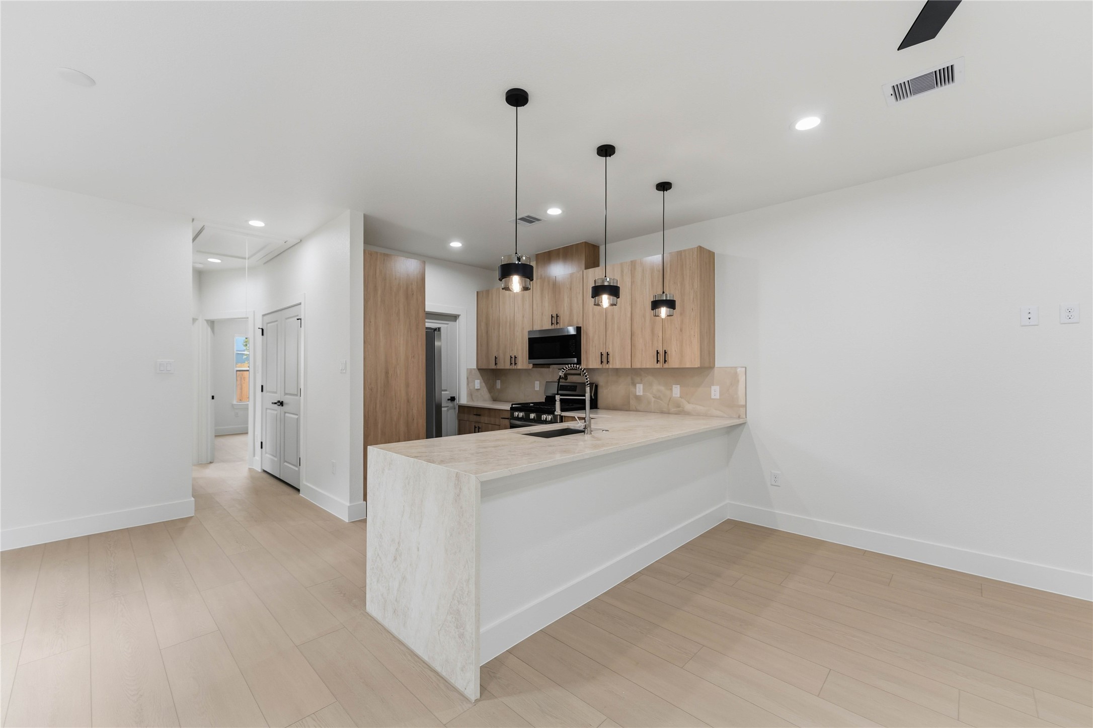 4314 Stassen Street Houston, TX 77051 - Photo 11 of 28 a large white kitchen with a large window