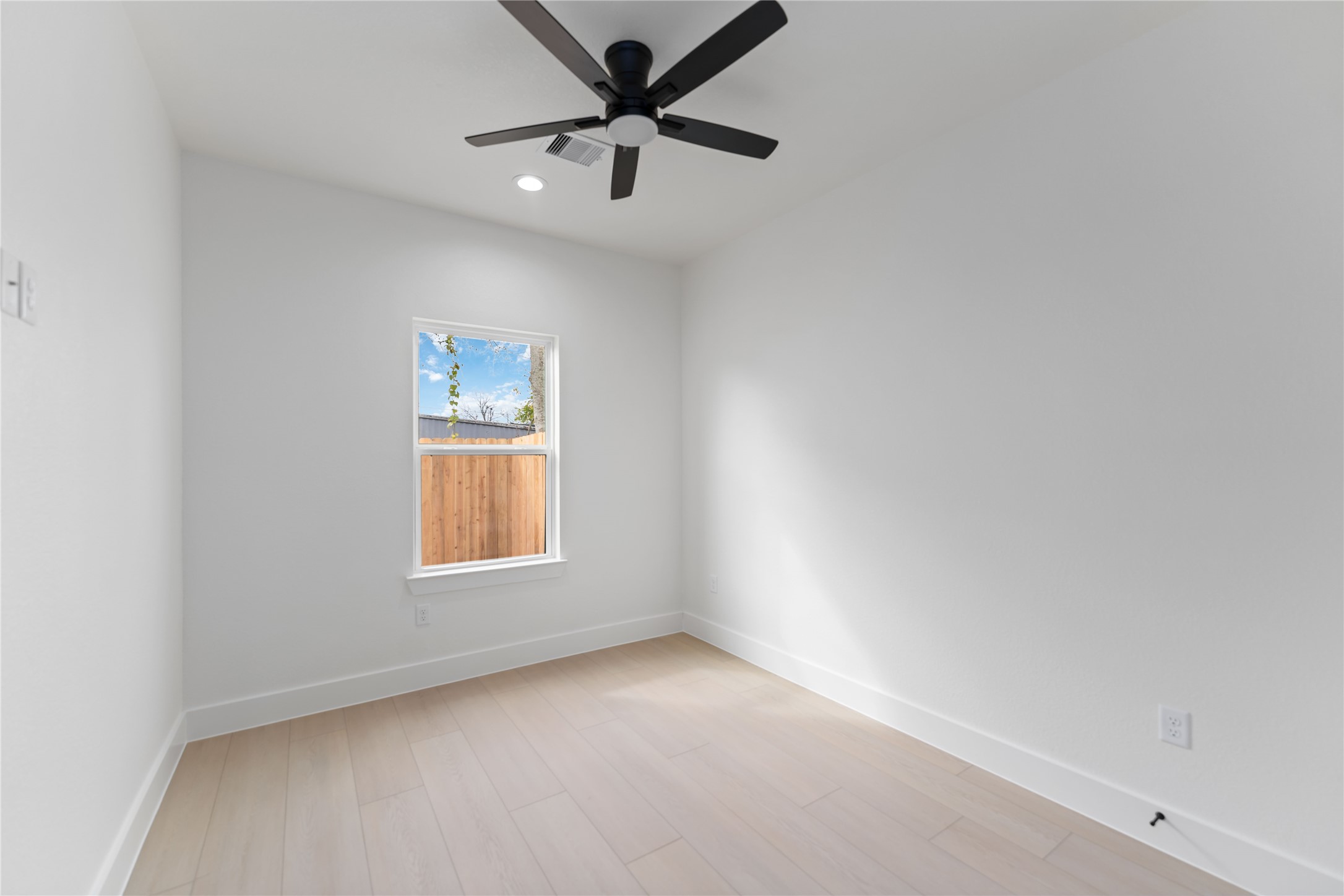 4314 Stassen Street Houston, TX 77051 - Photo 18 of 28 an empty room with a window and a fan