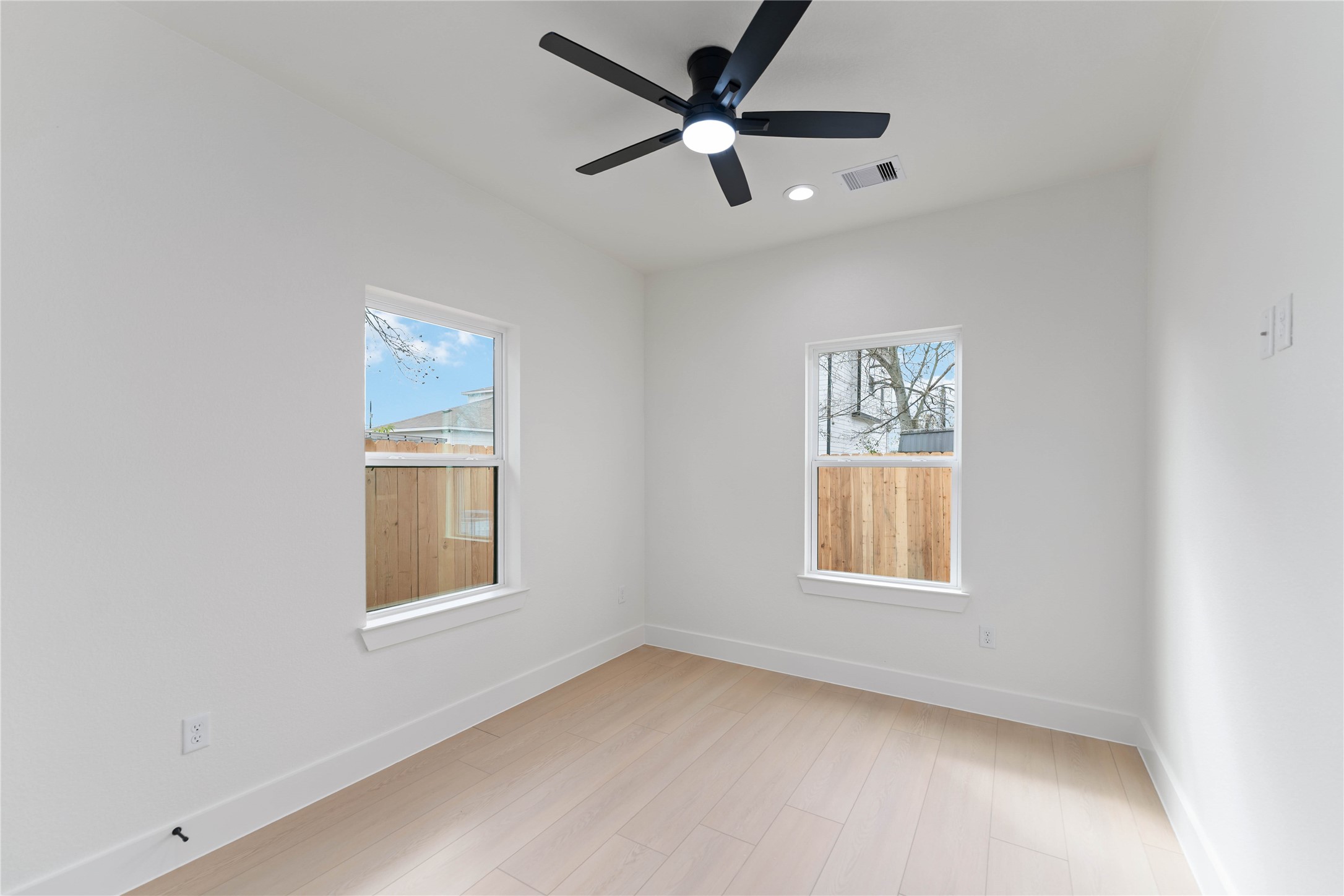 4314 Stassen Street Houston, TX 77051 - Photo 20 of 28 an empty room with windows and fan