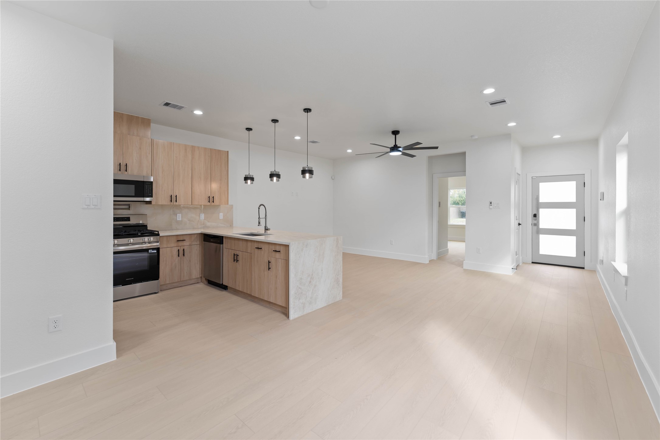 4314 Stassen Street Houston, TX 77051 - Photo 3 of 28 a view of a kitchen with a sink and dishwasher a refrigerator with white cabinets