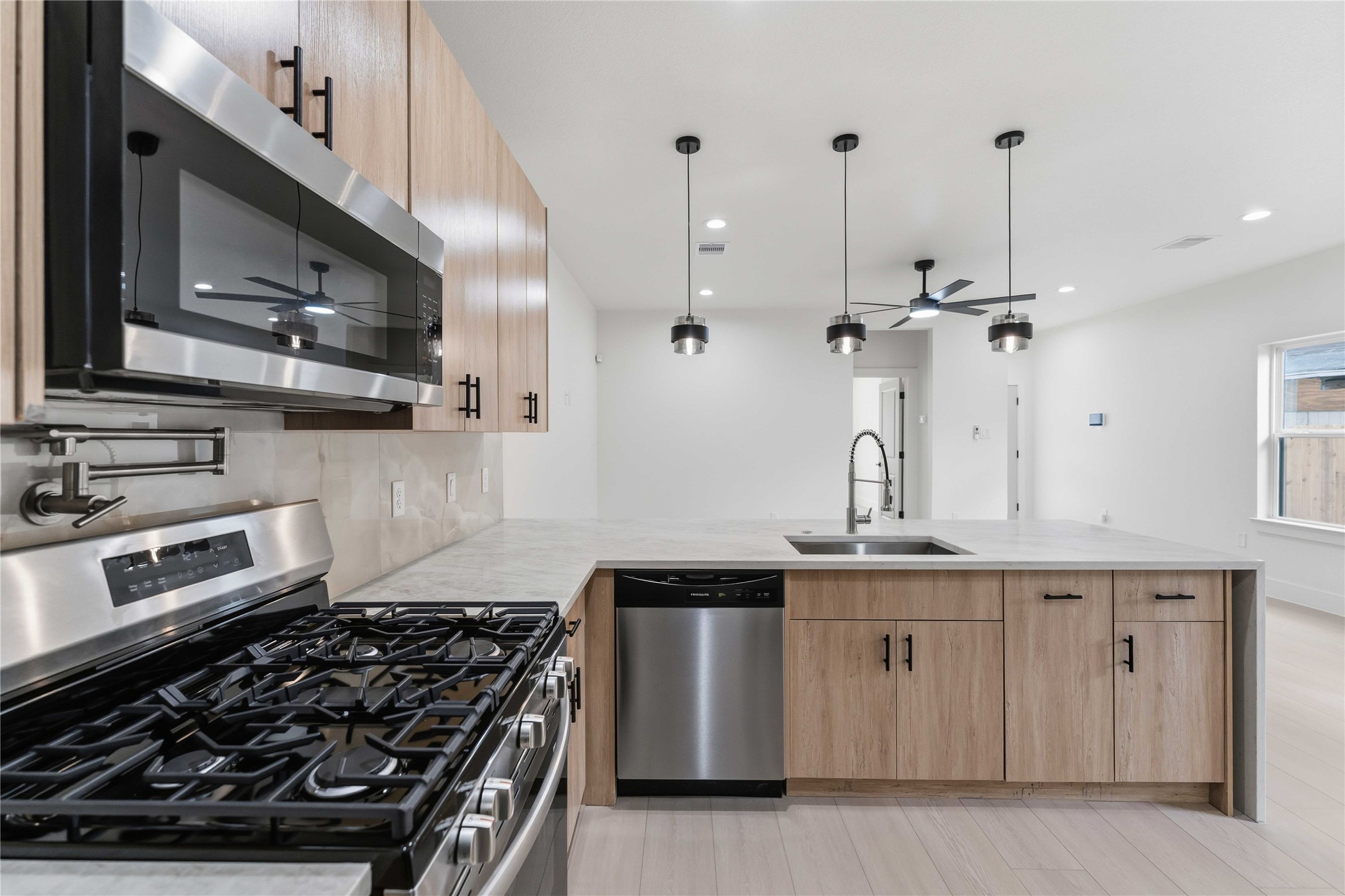 4314 Stassen Street Houston, TX 77051 - Photo 8 of 28 a kitchen with stainless steel appliances a sink and a stove