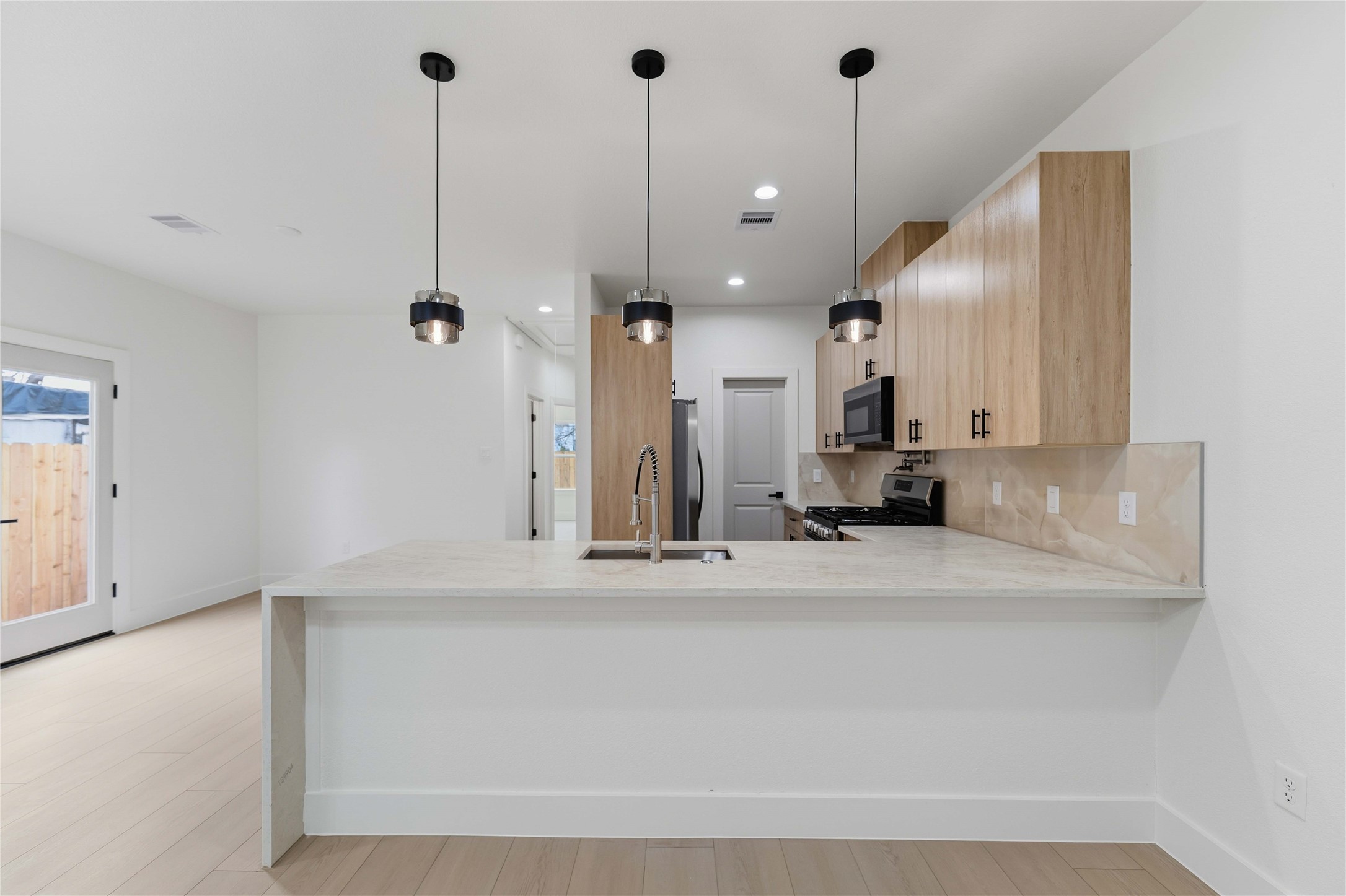 4314 Stassen Street Houston, TX 77051 - Photo 10 of 28 a view of a kitchen with a sink and cabinet with wooden floor